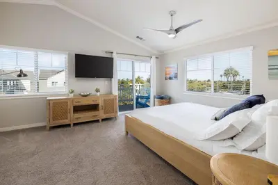 a bedroom with a large bed and a flat screen tv at Large 4 Bedroom Close To Beach in Encinitas
