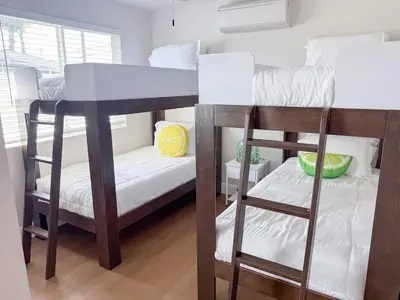 a bedroom with two bunk beds and a table at Lime Light La Mesa New 4BR 3BA Group Friendly in La Mesa