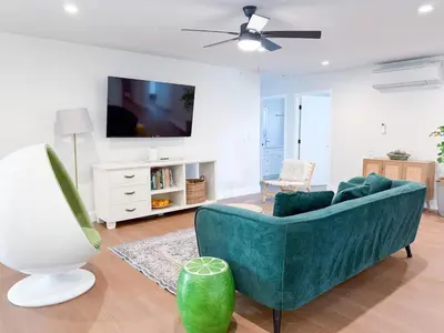 a living room with a blue couch and a tv at Lime Light La Mesa New 4BR 3BA Group Friendly in La Mesa