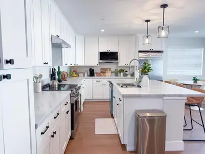a kitchen with white cabinets and a white counter top at Lime Light La Mesa New 4BR 3BA Group Friendly in La Mesa