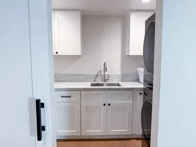 a kitchen with white cabinets and a sink at Lime Light La Mesa New 4BR 3BA Group Friendly in La Mesa