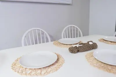 a table with white plates and a teddy bear on it at Central San Diego 3BR Home Near Beaches in San Diego