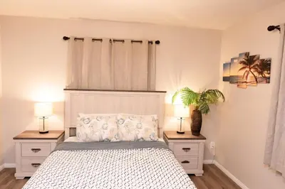 a bedroom with a white bed with two night stands at Central San Diego 3BR Home Near Beaches in San Diego