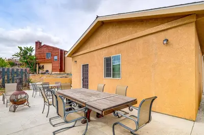 a wooden table and chairs on a patio at Game Room and Fire Pit Quiet Family Home in Bonita in Bonita