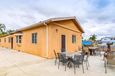 a building with a table and chairs on a patio at Game Room and Fire Pit Quiet Family Home in Bonita in Bonita