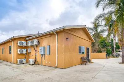 a building with air conditioners on the side of it at Game Room and Fire Pit Quiet Family Home in Bonita in Bonita