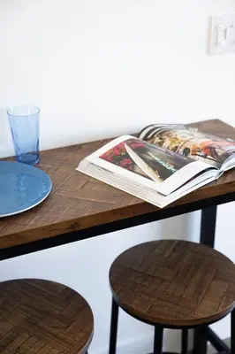 a table with a book and a plate and a glass at 2BD Sashas Bungalow Beach Vibes 1 Block Away in San Diego