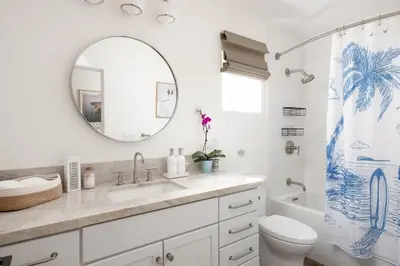 a bathroom with a sink and a toilet and a mirror at 2BD Sashas Bungalow Beach Vibes 1 Block Away in San Diego