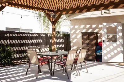 a patio with a table and chairs under a pergola at 2BD Sashas Bungalow Beach Vibes 1 Block Away in San Diego
