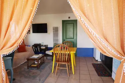 a living room with a yellow table and chairs at Colorful Casita Frida 1BD Retreat by Balboa Park in San Diego