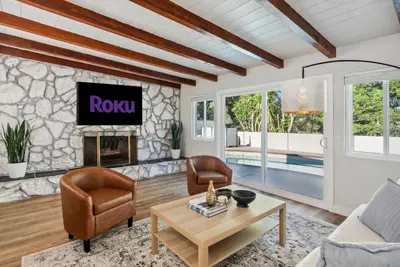 a living room with a fireplace and a tv at NEW Cozy Zen Pool Jacuzzi Home Heart of San Diego in San Diego