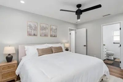 a white bedroom with a bed and a ceiling fan at NEW Cozy Zen Pool Jacuzzi Home Heart of San Diego in San Diego
