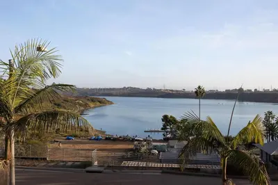 a view of a large body of water with palm trees at Water Views on Every Floor for this multi Holiday Home - Walk to the Beach in Carlsbad
