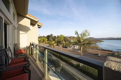 a balcony with benches and a view of the water at Water Views on Every Floor for this multi Holiday Home - Walk to the Beach in Carlsbad