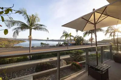 a patio with a bench and a view of the ocean at Water Views on Every Floor for this multi Holiday Home - Walk to the Beach in Carlsbad
