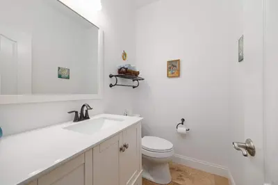 a white bathroom with a sink and a toilet at Water Views on Every Floor for this multi Holiday Home - Walk to the Beach in Carlsbad