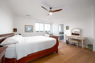 a bedroom with a bed and a ceiling fan at Water Views on Every Floor for this multi Holiday Home - Walk to the Beach in Carlsbad