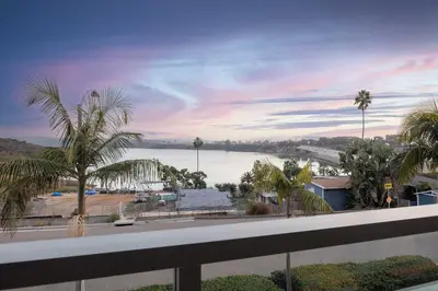 a view of a body of water with palm trees at Water Views on Every Floor for this multi Holiday Home - Walk to the Beach in Carlsbad