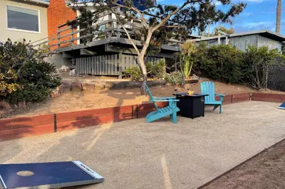 two blue chairs and a table on a patio at Ocean Views Walk to the Beach with King Suite in Encinitas
