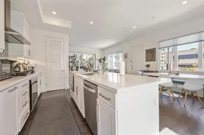 a kitchen with white cabinets and a large white counter top at Walk to Balboa Park and Little Italy LUX Townhome in San Diego