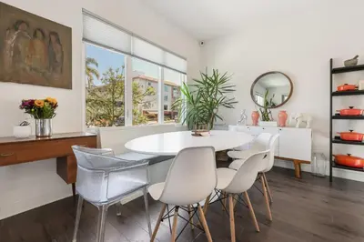 a dining room with a white table and chairs at Walk to Balboa Park and Little Italy LUX Townhome in San Diego