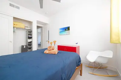 a teddy bear sitting on a bed in a bedroom at Walk to Balboa Park and Little Italy LUX Townhome in San Diego