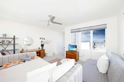 a living room with a couch and a tv at Walk to Balboa Park and Little Italy LUX Townhome in San Diego