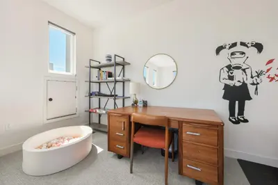 a bathroom with a desk and a bath tub next to a mirror at Walk to Balboa Park and Little Italy LUX Townhome in San Diego