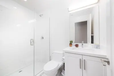 a bathroom with a toilet and a sink and a shower at Walk to Balboa Park and Little Italy LUX Townhome in San Diego
