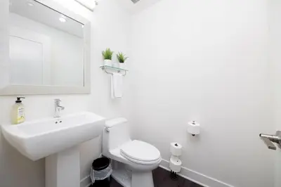 a white bathroom with a sink and a toilet at Walk to Balboa Park and Little Italy LUX Townhome in San Diego