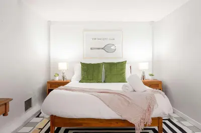a bedroom with a large bed with green pillows at Sunset Balcony Views 1 Mile to Beach 7 Beds in San Diego