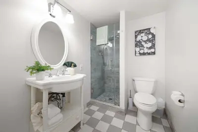 a white bathroom with a sink and a shower at Sunset Balcony Views 1 Mile to Beach 7 Beds in San Diego