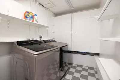 a small kitchen with a washer and dryer in it at Sunset Balcony Views 1 Mile to Beach 7 Beds in San Diego