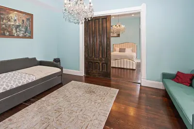 a living room with a couch and a chair at 1900's Victorian Home Sleeps 22 8BDRM 3Bath in San Diego