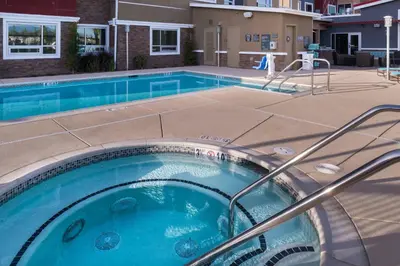 a large swimming pool in a courtyard with a building at Residence Inn by Marriott Temecula Murrieta in Murrieta
