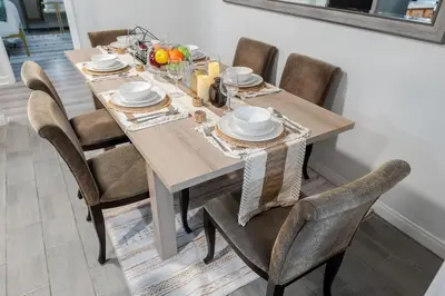 a dining room table with chairs and a tablecloth on it at Entire Private Home with 4 Bedrooms 3 Bathrooms, King Bed, Big Yard, Prime Area, Ranch Style, Available Now in La Mesa