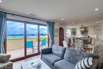 a living room with a couch and a view of a kitchen at Casa Hermosa in San Diego