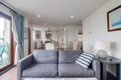 a living room with a couch and a dining room at Casa Hermosa in San Diego