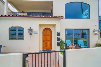 a house with a wooden door and a balcony at Casa Hermosa in San Diego