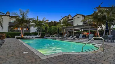 a swimming pool in front of a house at Close to Beach w Patio Resort Amenities The Point at Corniche by AvantStay STR16-0458 in Dana Point
