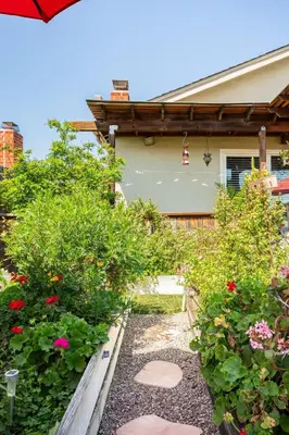a garden with flowers and plants in front of a house at Comfortable Home in San Diego Lemon Grove Area in Lemon Grove