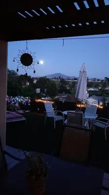 a view of a patio with chairs and an umbrella at Comfortable Home in San Diego Lemon Grove Area in Lemon Grove