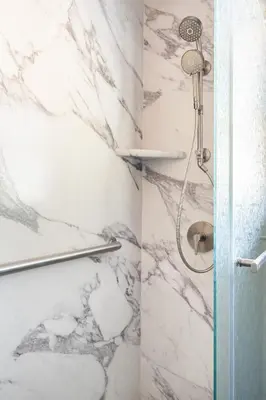 a bathroom with a shower with marble walls at Comfortable Home in San Diego Lemon Grove Area in Lemon Grove