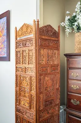 a wooden door in a room next to a dresser at comfortable home in San Diego Lemon Grove area in Lemon Grove