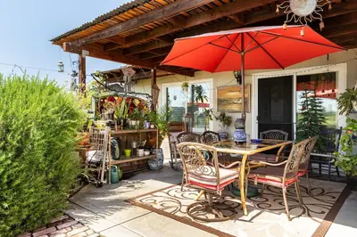 a table and chairs with an umbrella on a patio at comfortable home in San Diego Lemon Grove area in Lemon Grove