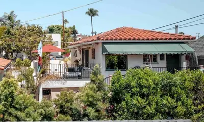 a white house with a red roof at Charming Casita with City and Bay Views in San Diego