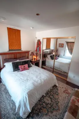 a bedroom with two beds and a large mirror at Charming Casita with City and Bay Views in San Diego