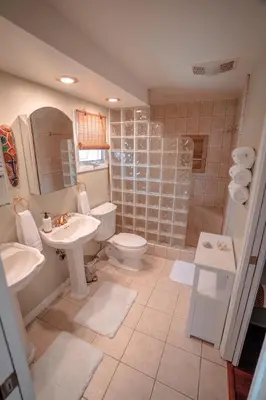 a bathroom with a sink and a toilet and a shower at Charming Casita with City and Bay Views in San Diego
