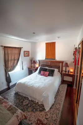 a bedroom with a large white bed and a window at Charming Casita with City and Bay Views in San Diego