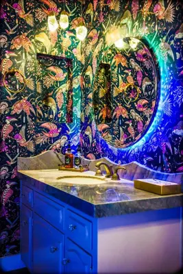 a bathroom with a sink and a colorful wall at Enchanted Estate With Animals Lightscapes and Whimsy in Bonsall